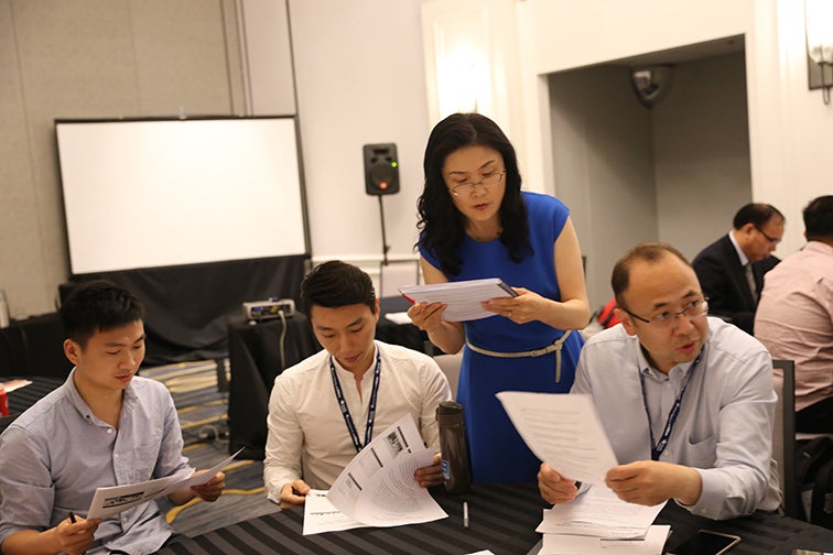 Gao reviewing papers with colleagues 