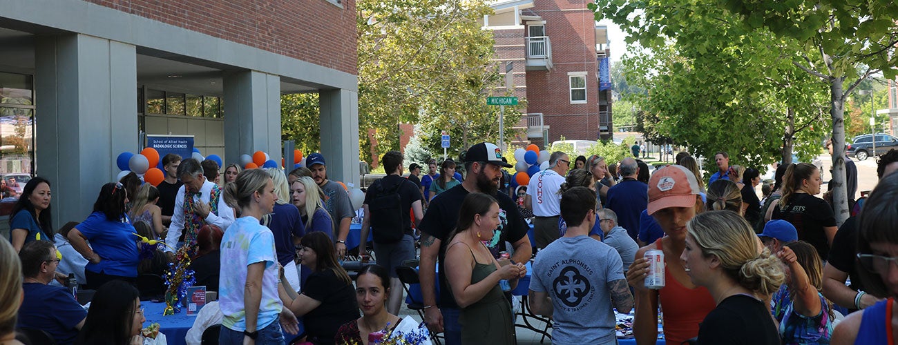 A crowd of students, faculty and staff outside the Norco building during the 2022 welcome barbecue