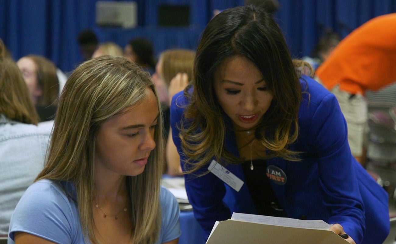 Mary Crowell works with an incoming student at orientation in July 2019