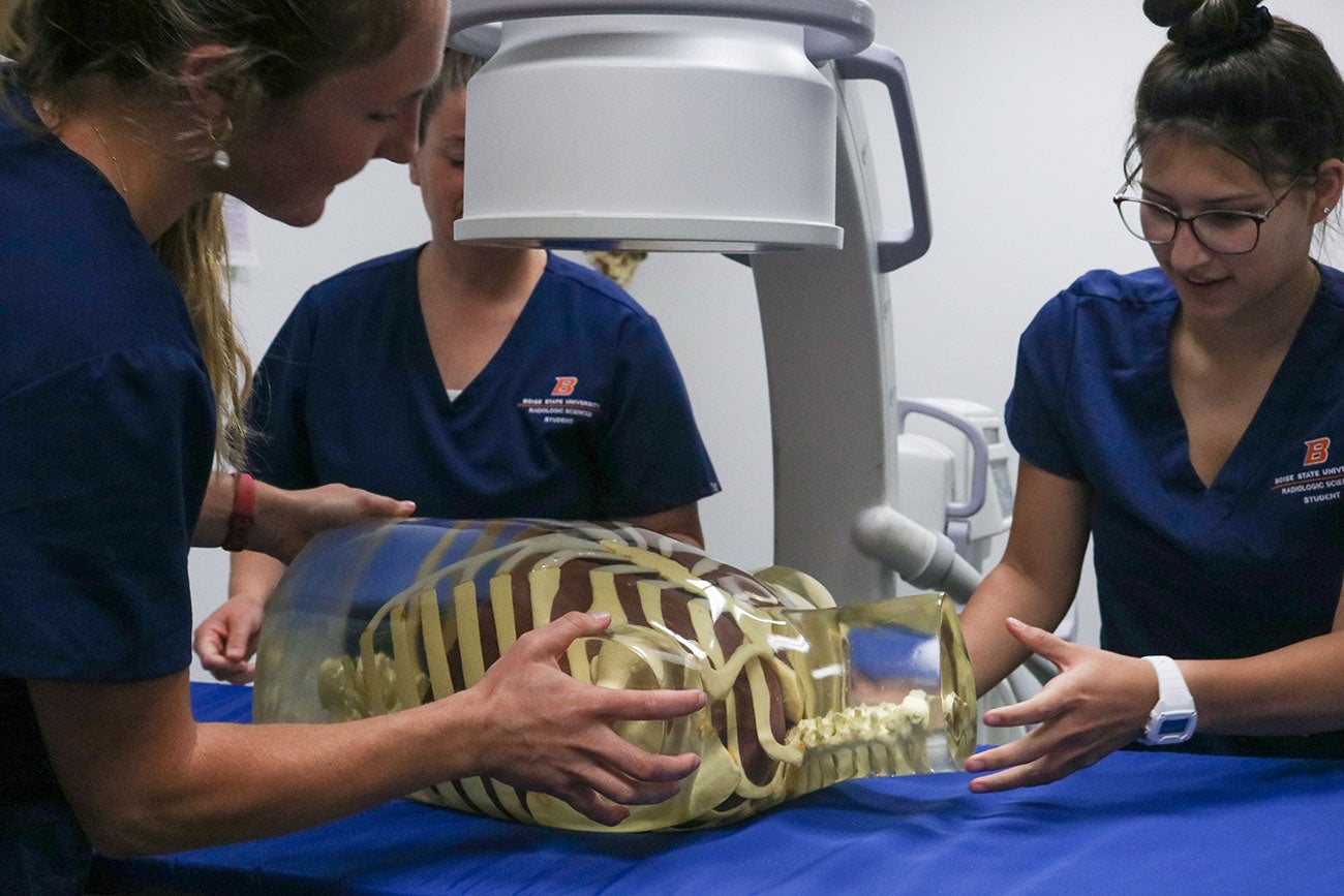 Radiologic Sciences students position the new C-arm on model torso