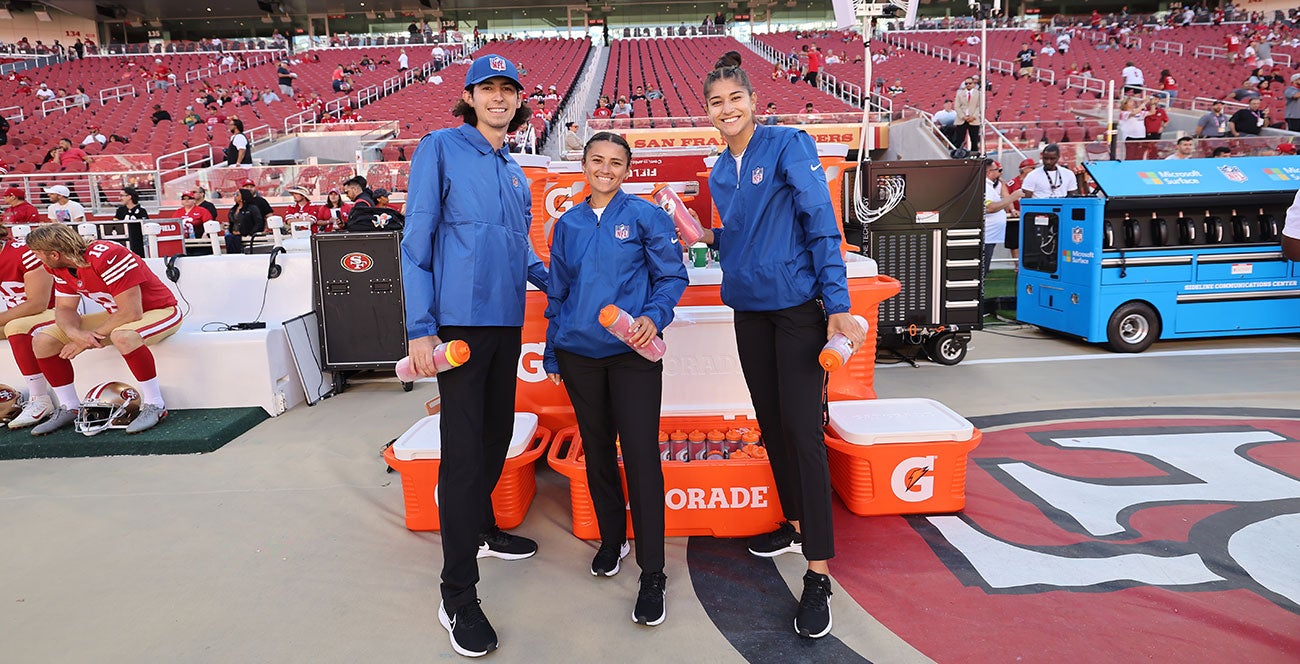 Sabrina Ingram-Rajan stands in the center with fellow athletic training interns on the sidelines in Levi's Stadium