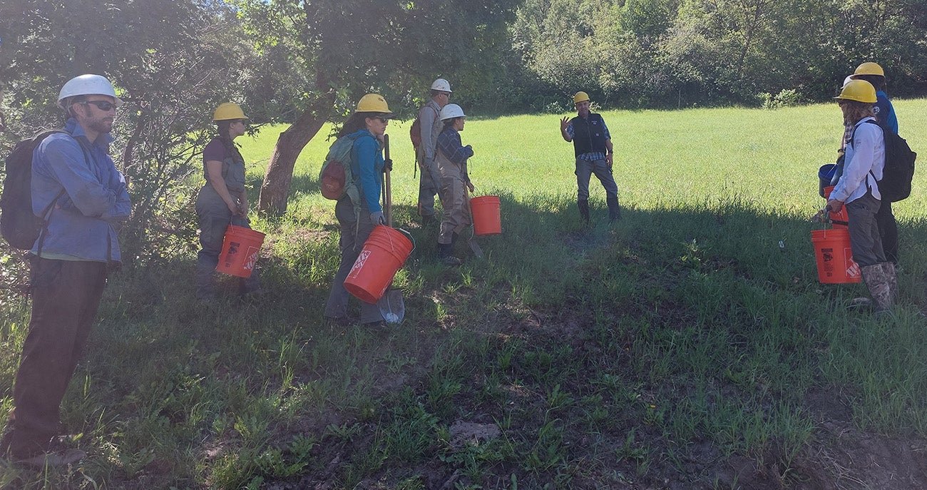 The Boise State MRRMaid crew assembles for instructions on how to build dams to attract beavers.