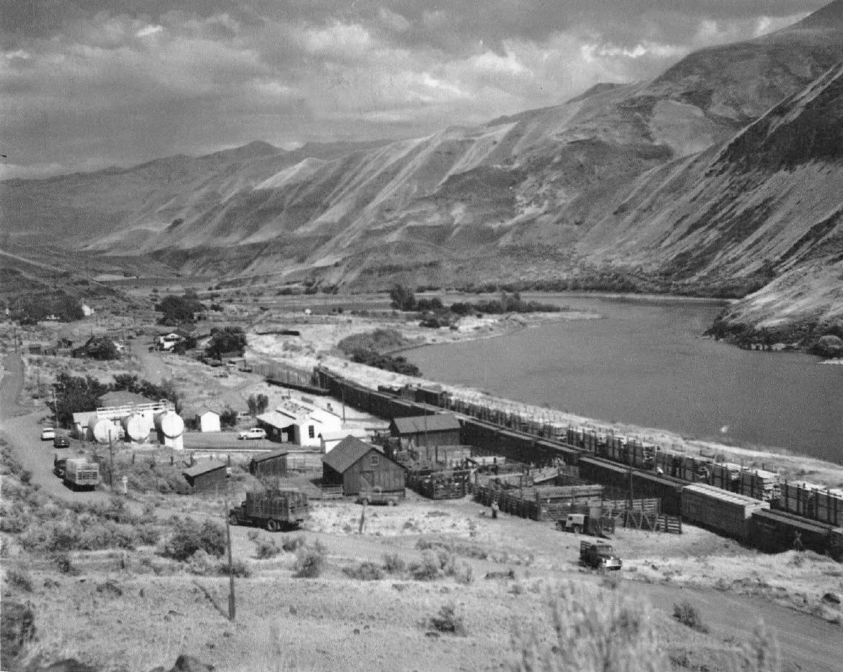 town next to river and mountains, black and white photo
