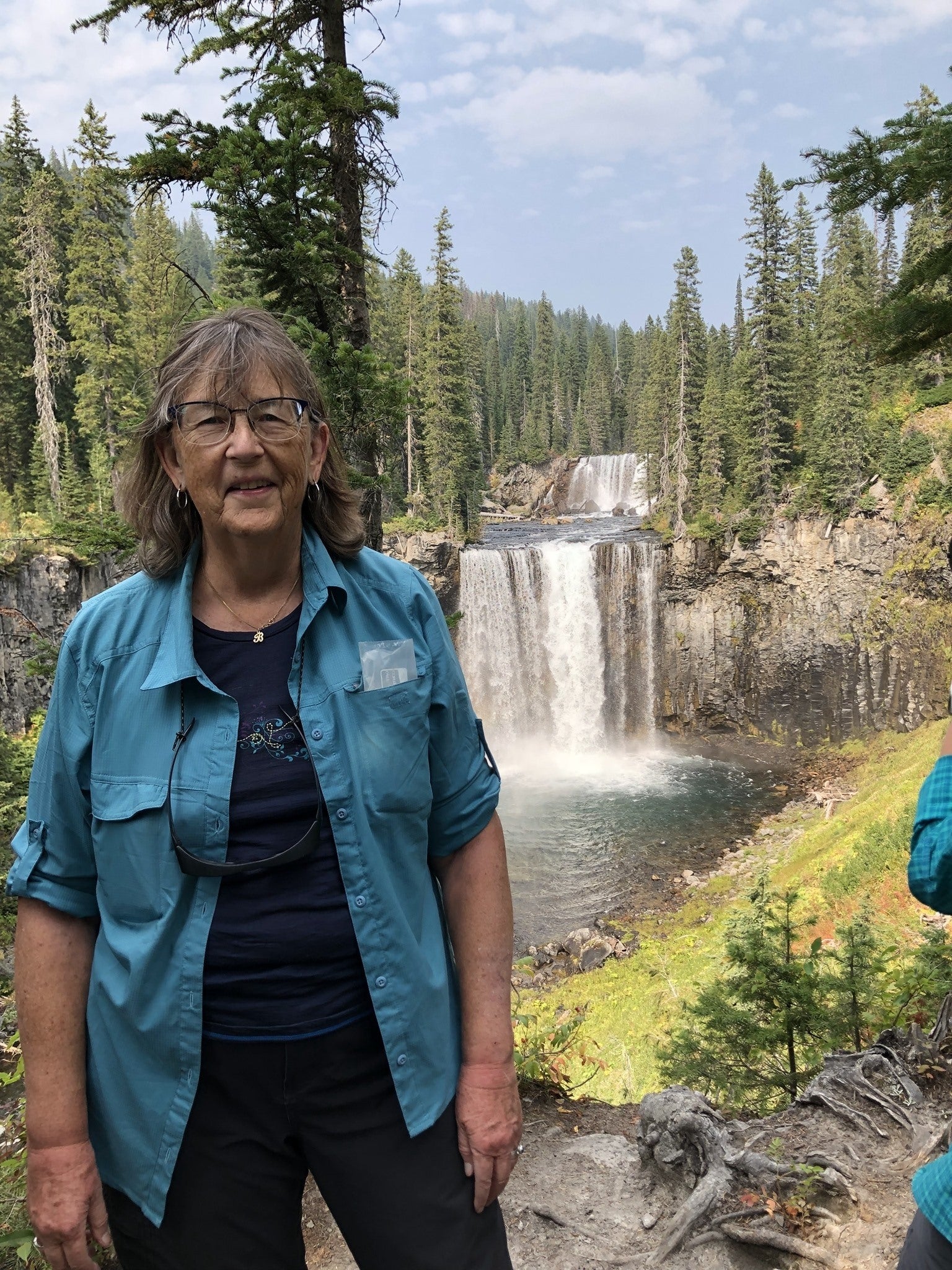 Barb Forderhase stands in front of the Bechler River in Yellowstone National Park