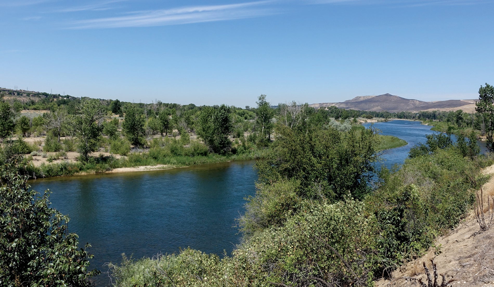 A river winds around a bend in the desert. 