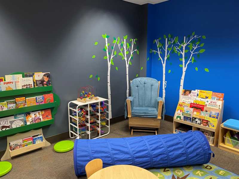 Colorful room with rocking chair and children's toys and books