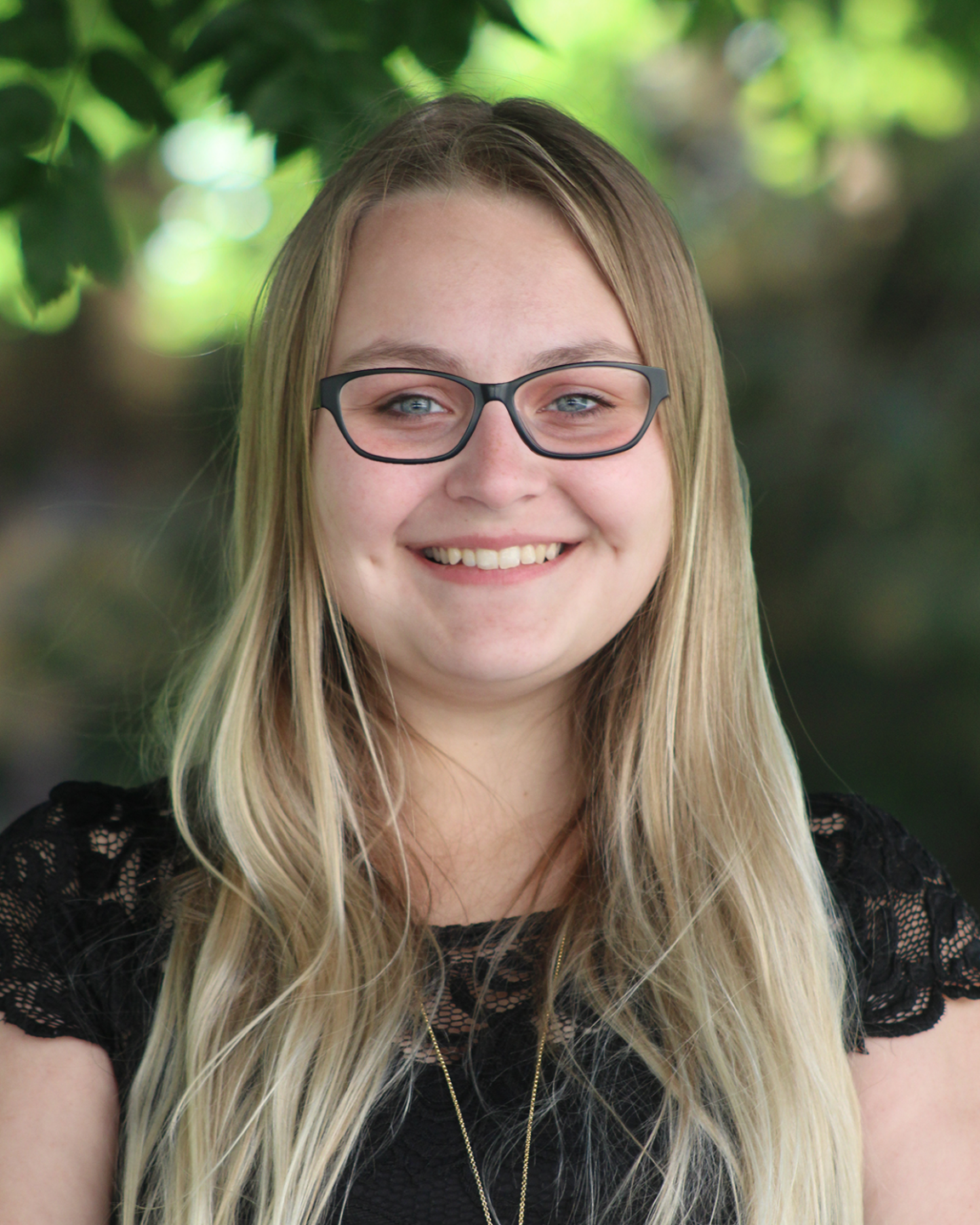 close up headshot of Kolby Alloway outside and wearing eye glasses