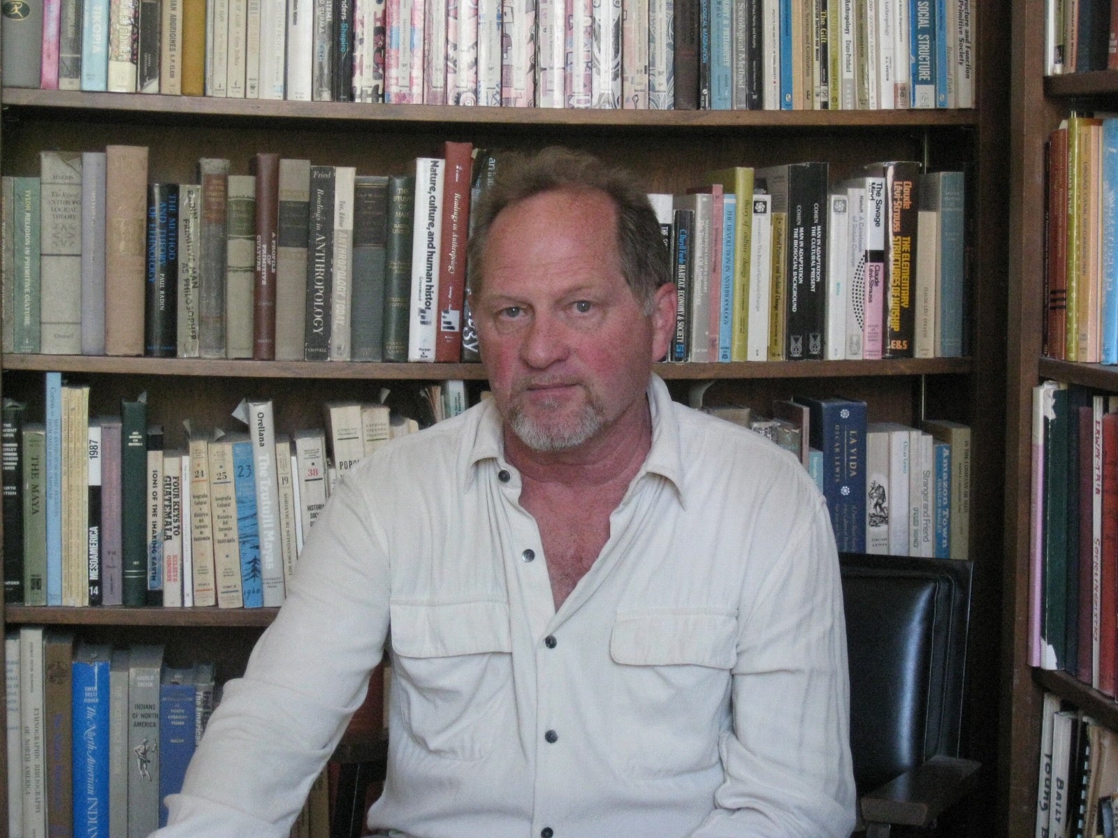 Professor Emeritus Dayley sitting in his office in front of bookshelf