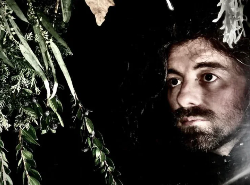 Sean Dahlman among plants in a black night