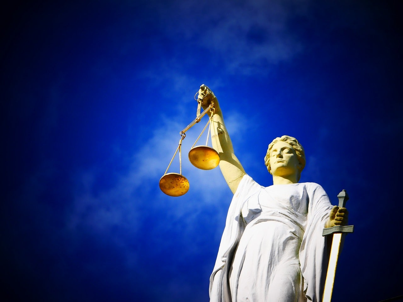 A statue holding scales and a sword
