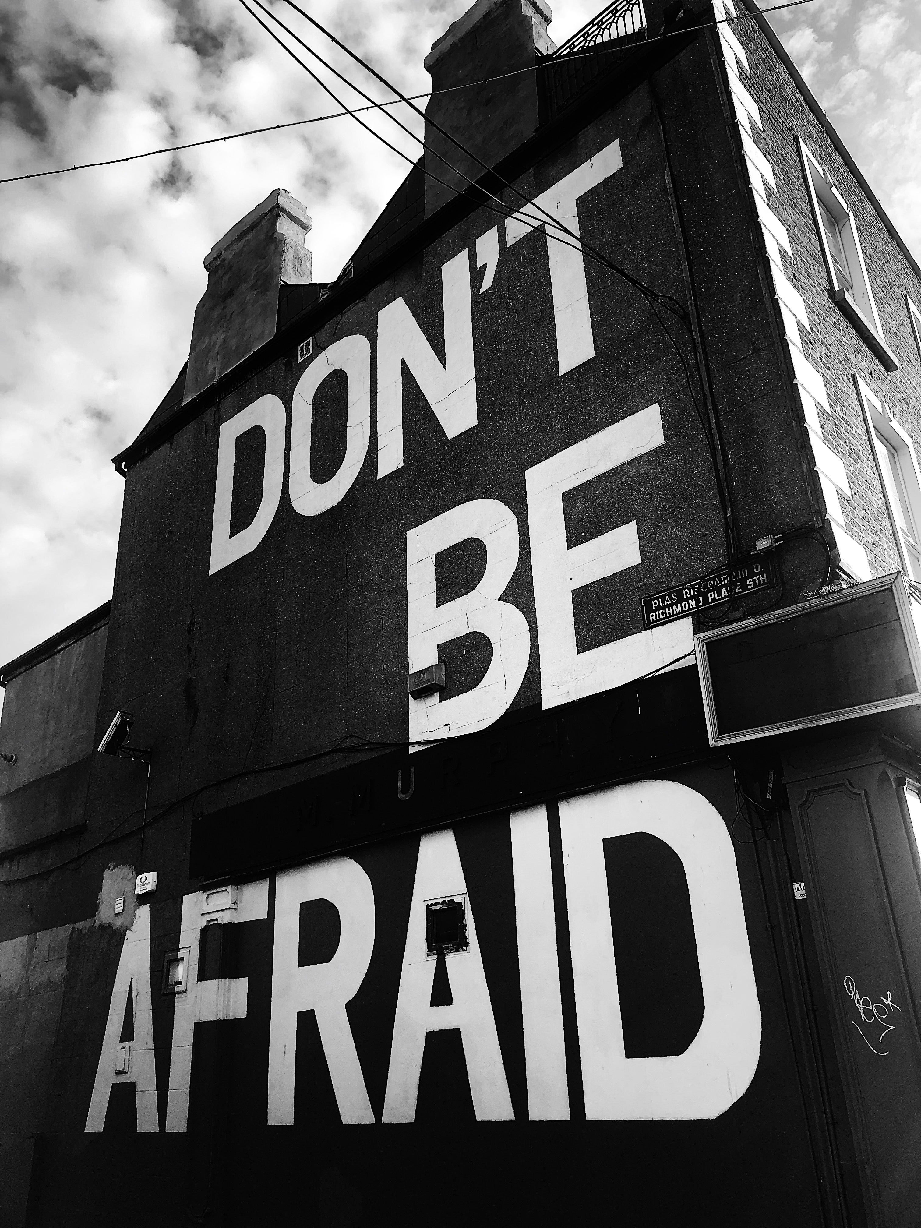 Mural on building facade reads 'Don't be afraid'