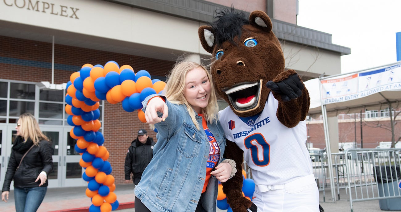 student with Buster Bronco mascot