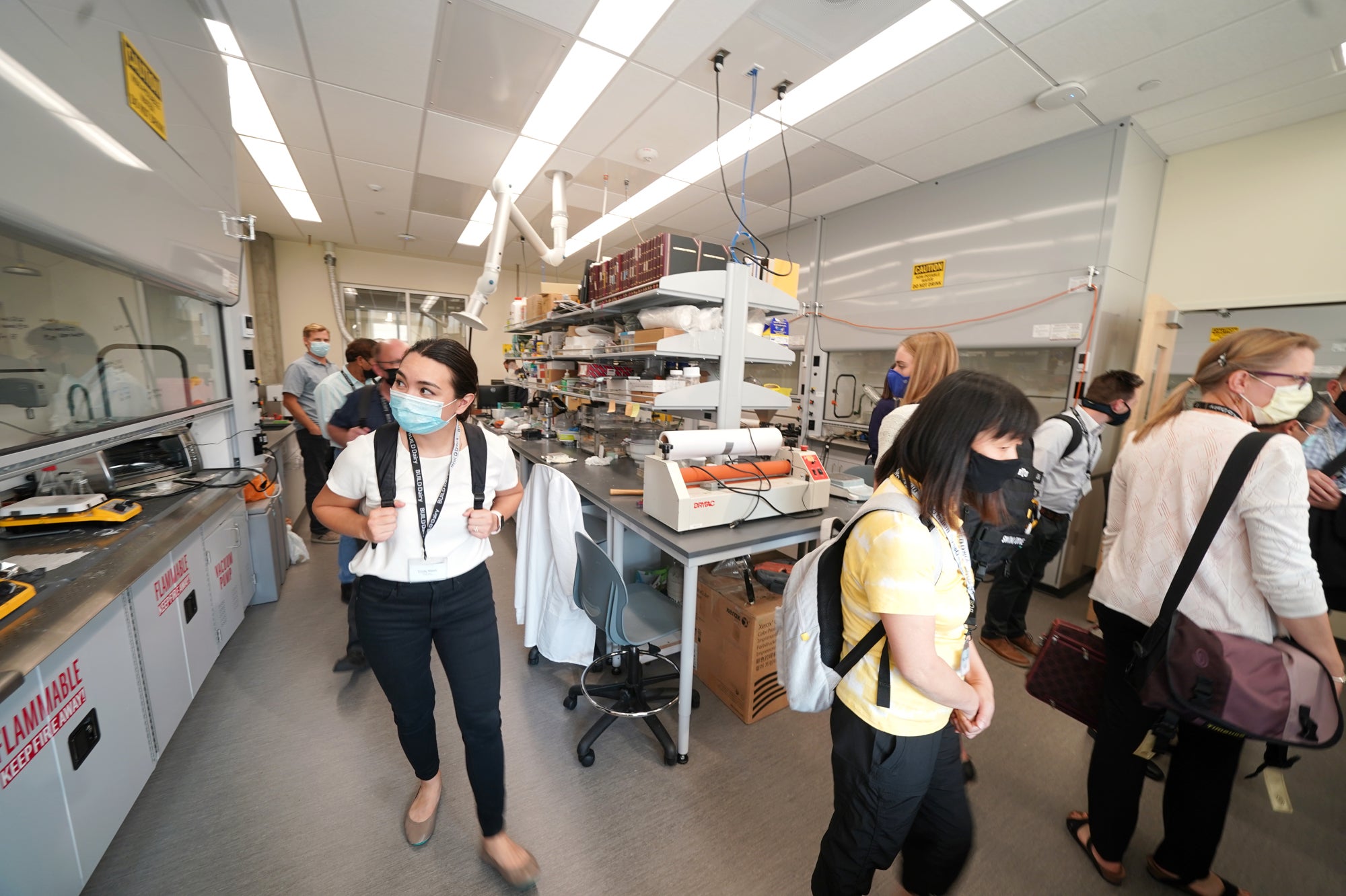 people walk through lab space
