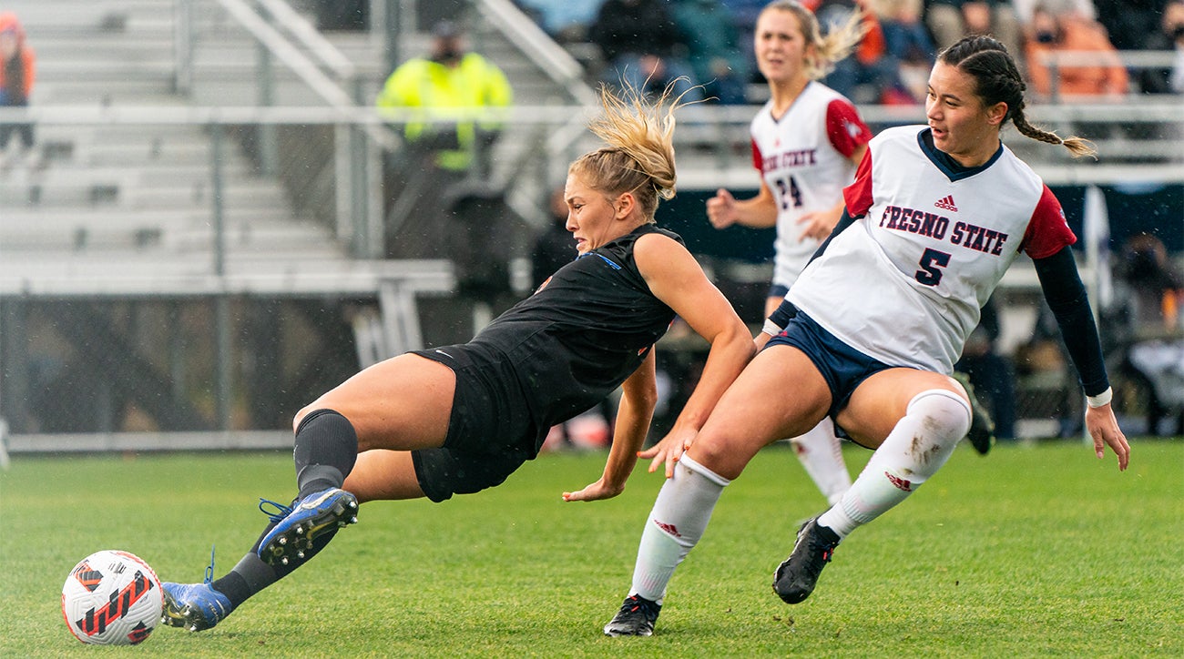 Female soccer player diving towards ball in a match between Boise State and Fresno