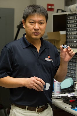 Professor holding microchip