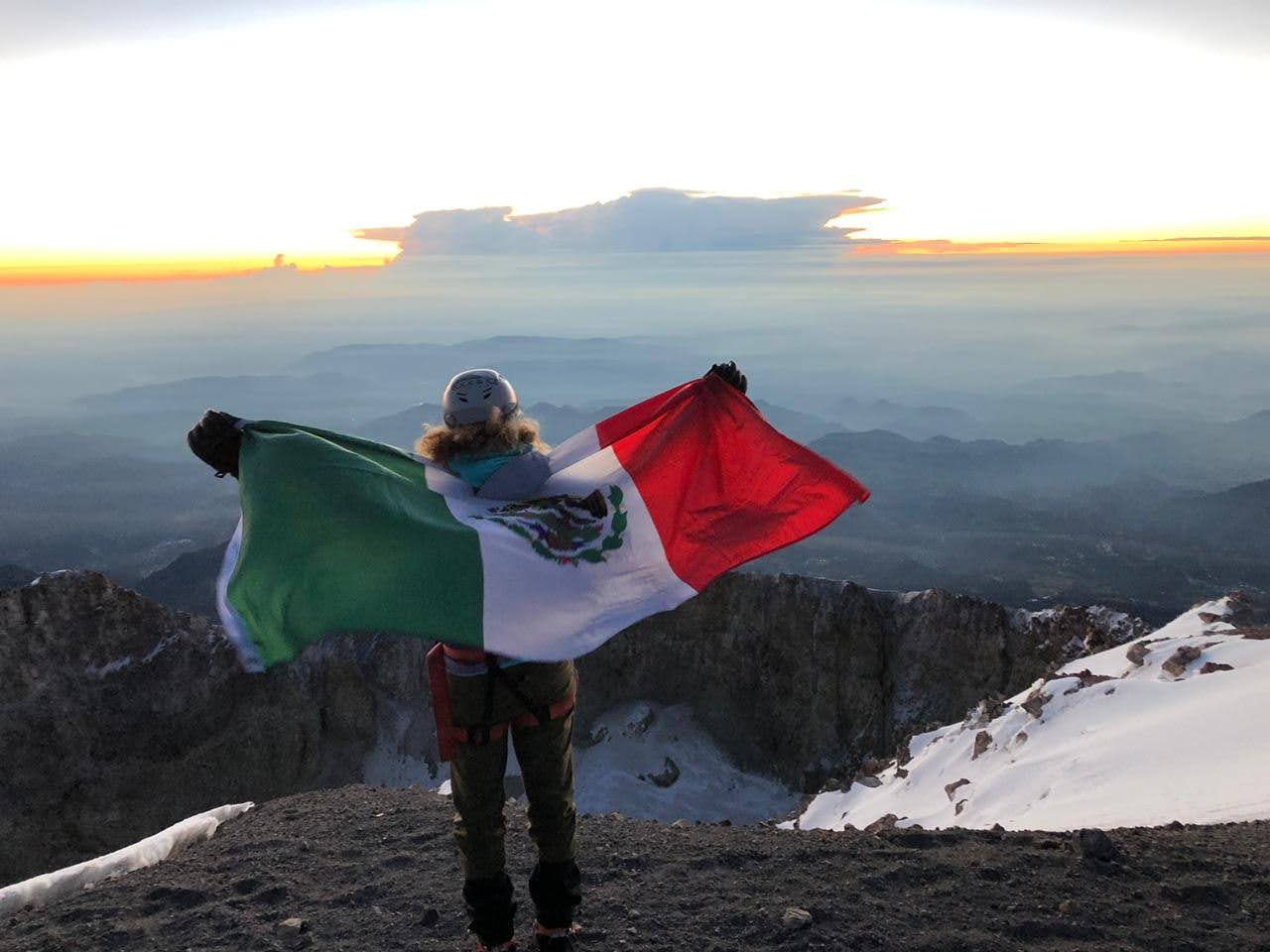 Andrea Dorantes posing on summit with Mexican flag