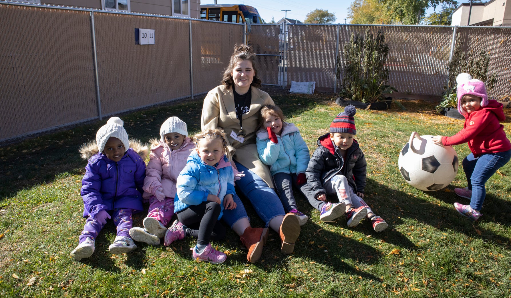 Hannah Sharpe with children outside at Head Start preschool