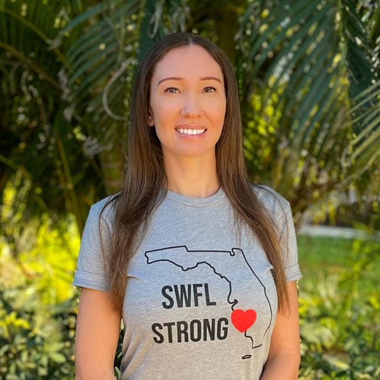 Headshot of Jovita Gardner standing outside in a shirt that reads "SWFL Strong" with an outline of Florida.