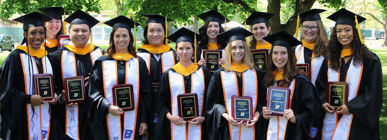 First class of Master of Science in Genetic Counseling pose in their regalia