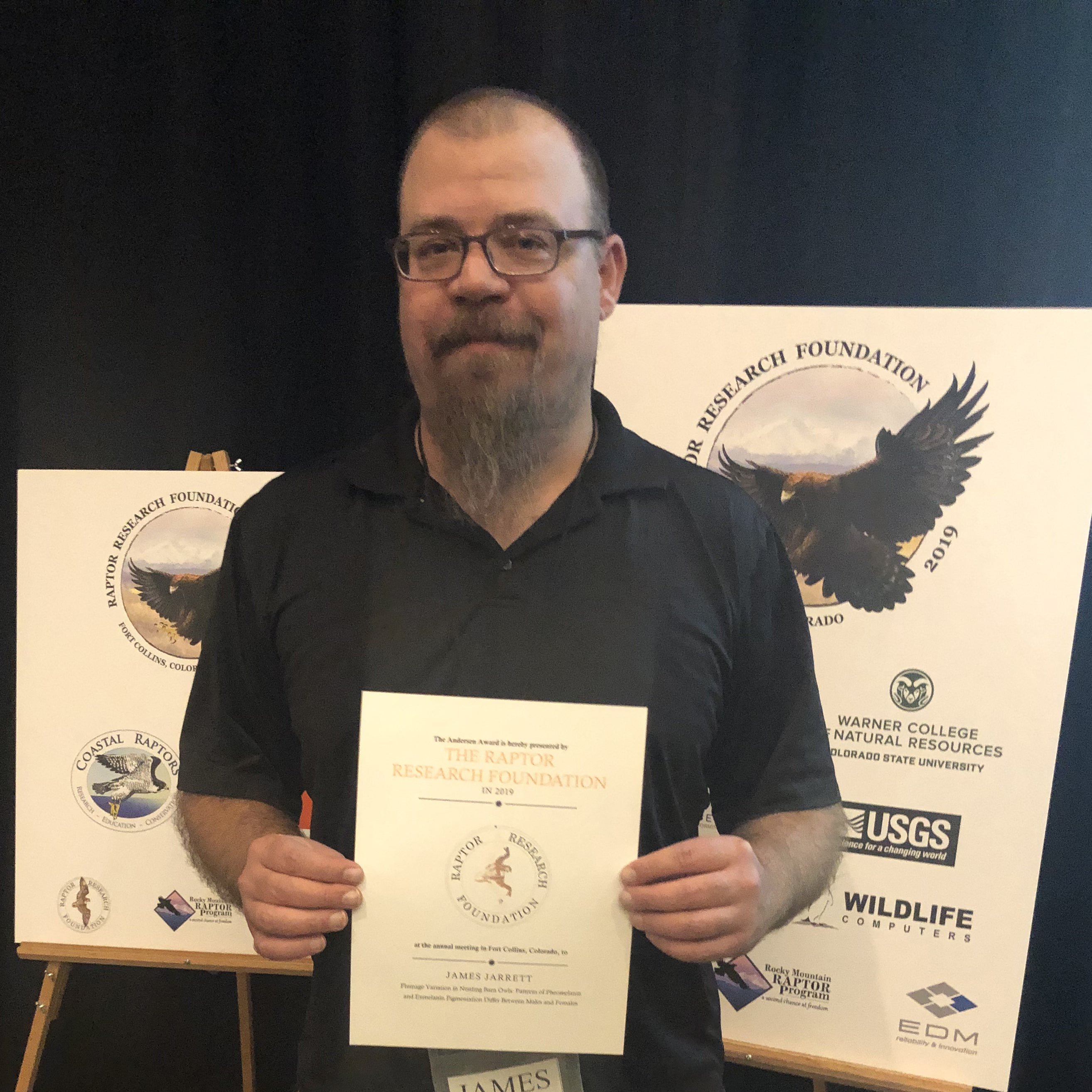 James holding award