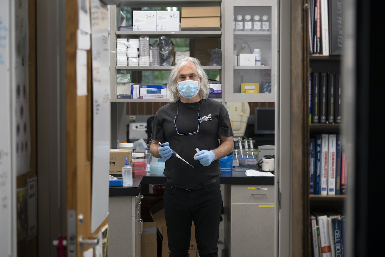 Greg Hampikian in a lab holding equipment