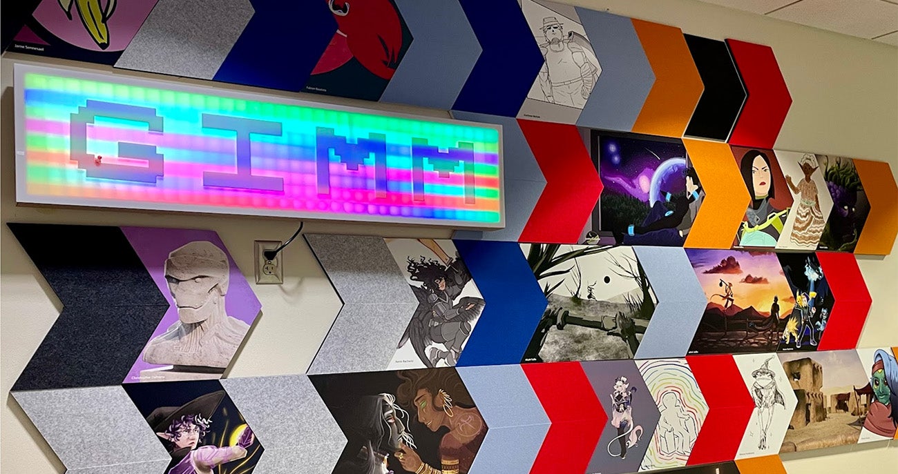 Photo of a neon sign with the letters GIMM in the Albertsons Library