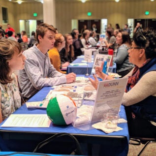 Students discuss job opportunities with an organization at the Meet and Greet.