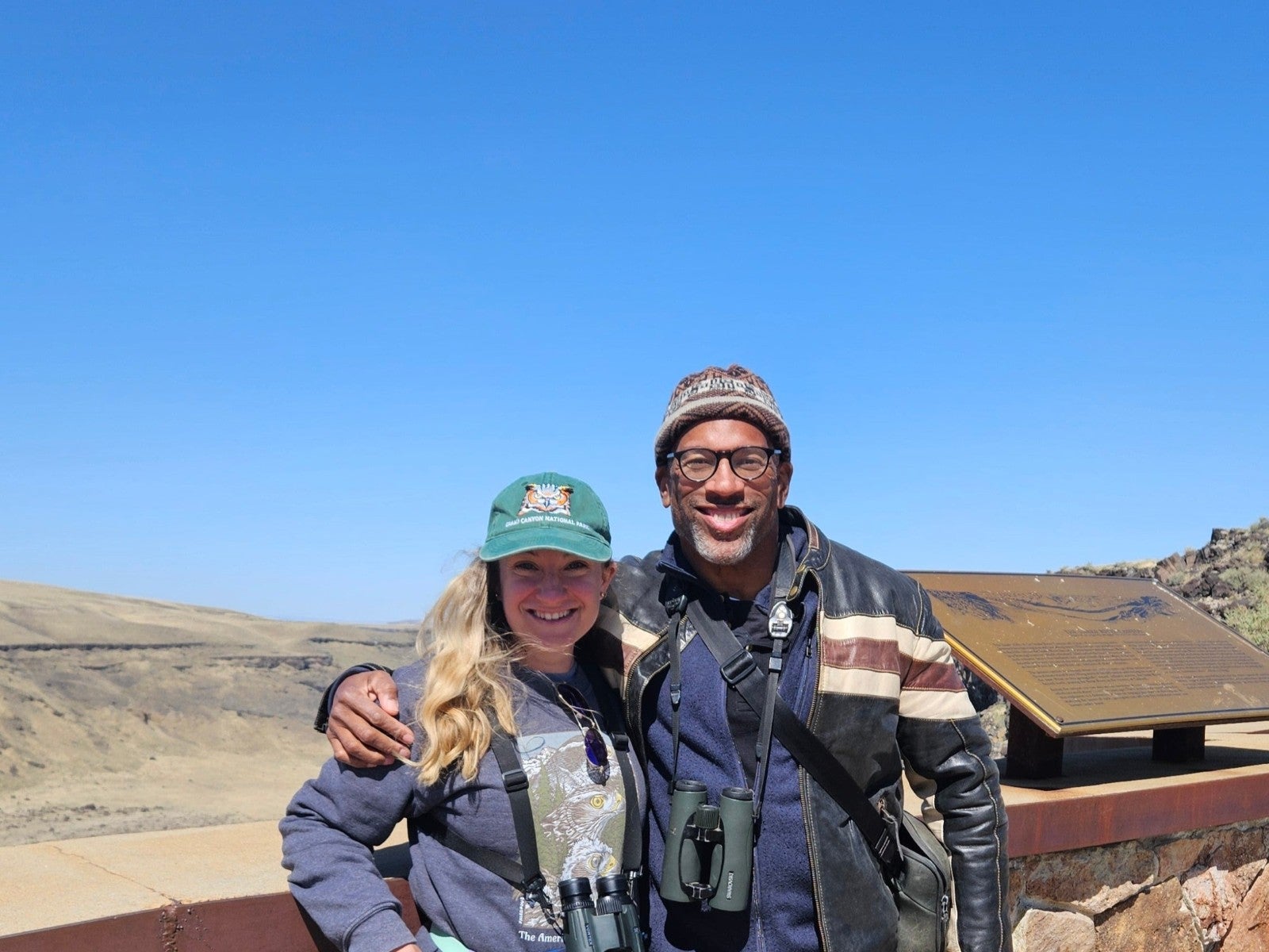 Boise State student with guest speaker posing for a photo in the Morley Nelson Snake River Birds of Prey National Conservation Area.