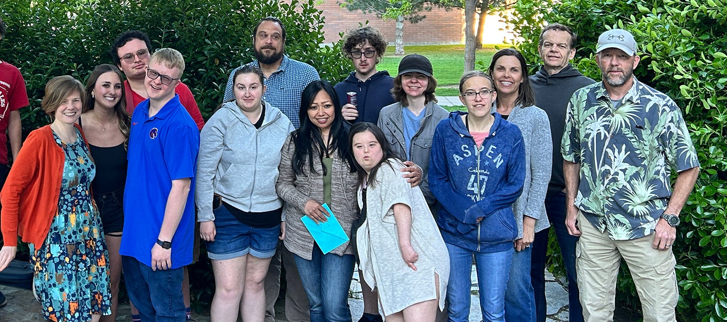 A group of persons pose outside