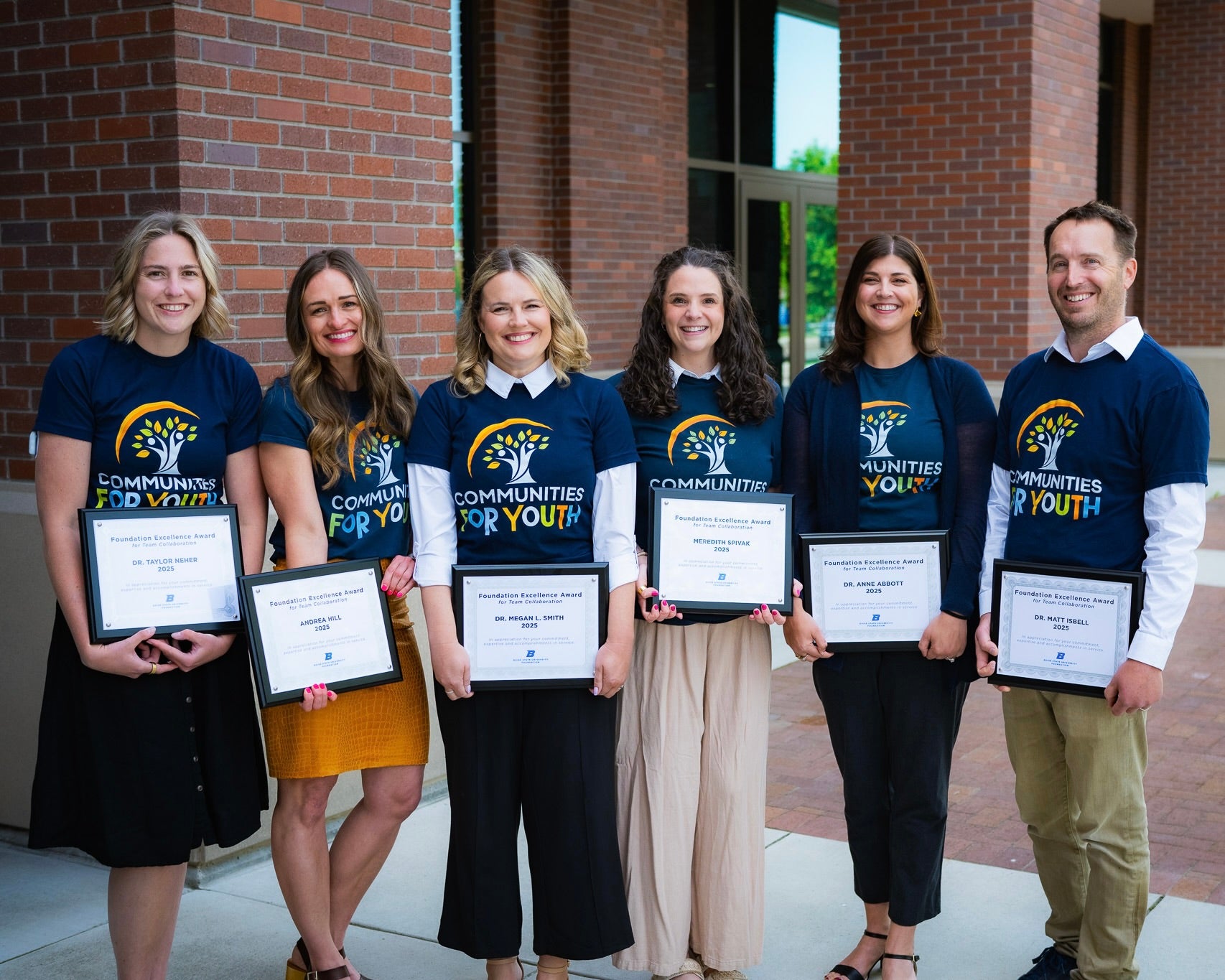Six of the Communities for Youth team members pose with their Foundation Excellence Award certificates