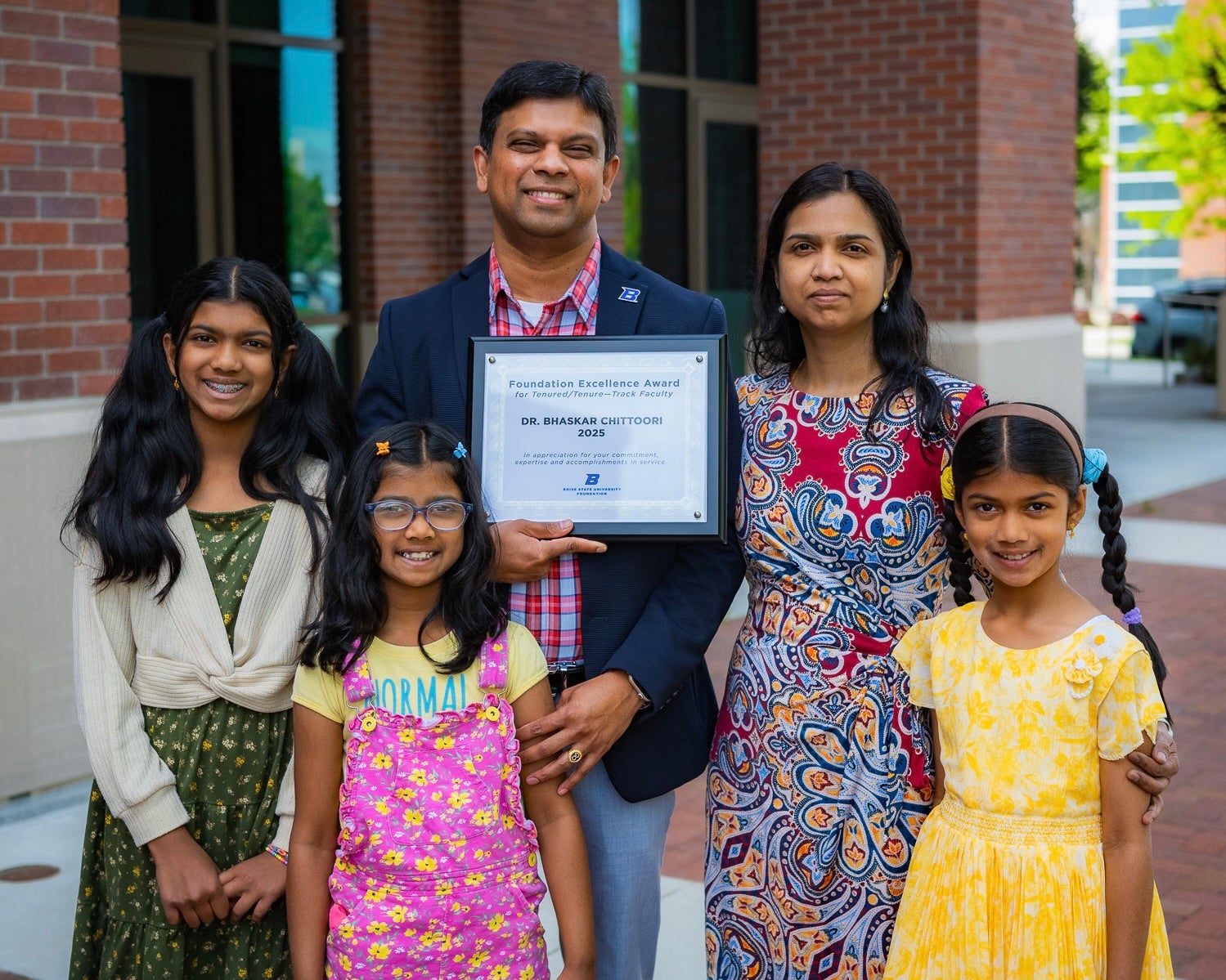 Bhaskar Chittoori poses with his family and Foundation Excellence Award certificate