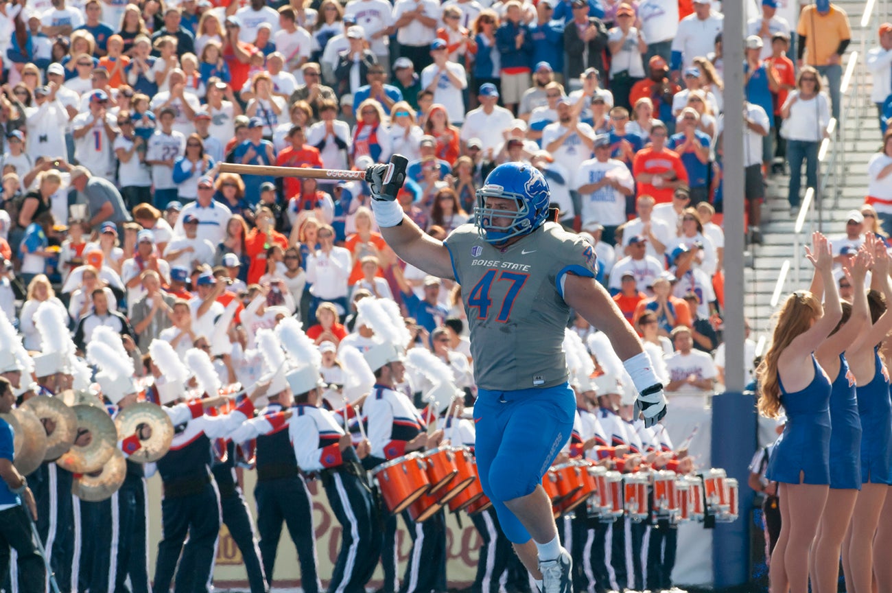 Dan Paul carrying the hammer out onto the football field.