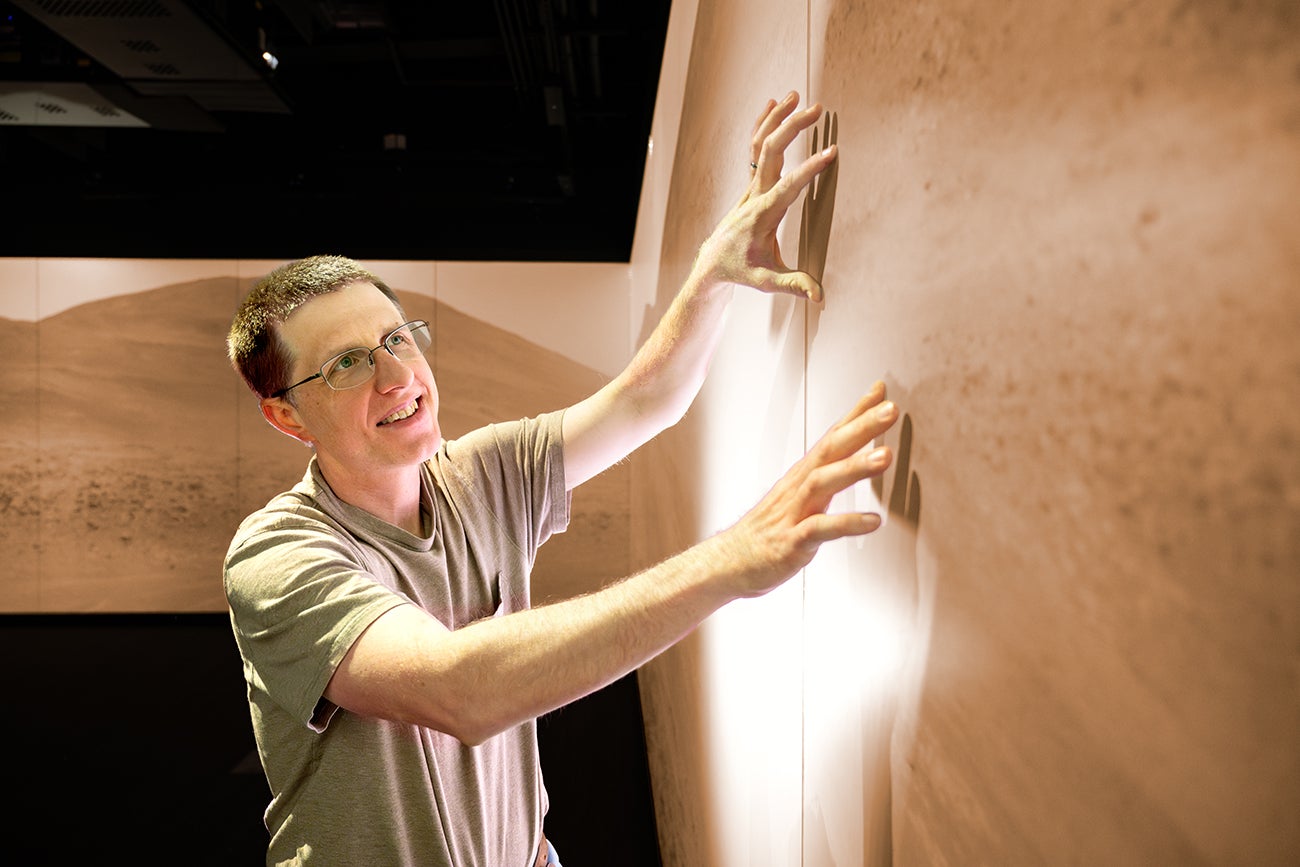 Brian Jackson interacts with NASA imagery in the Stein Luminary.