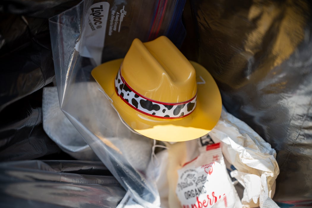 Yellow plastic hat in trash