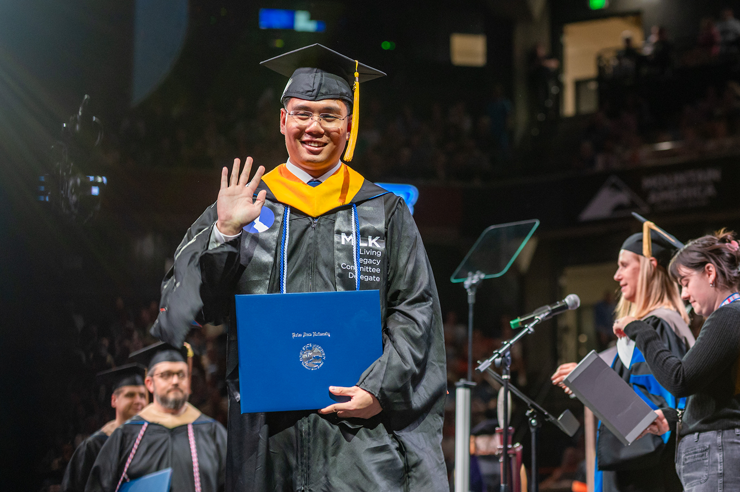 Gregor Posadas walks the stage at the 2025 spring commencement at Boise State with his Master of Science in Civil Engineering.
