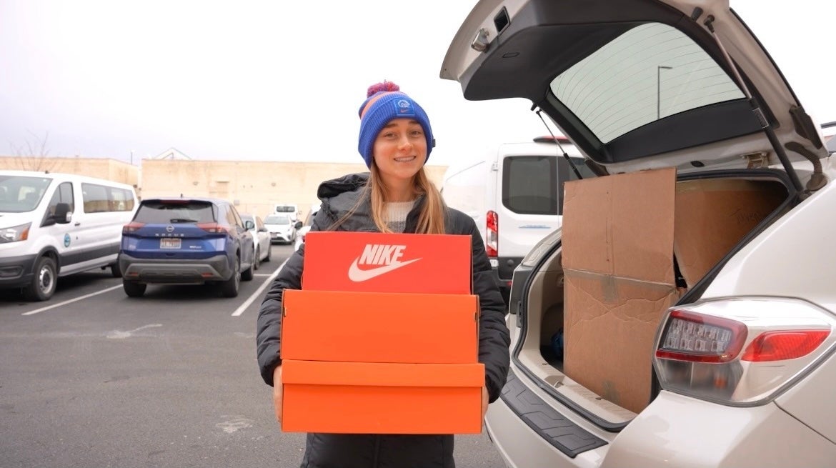 A person hold Nike shoe boxes