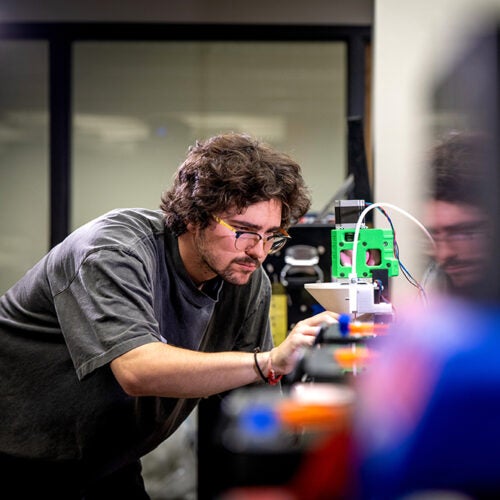 Kade Bolen working with 3D printer