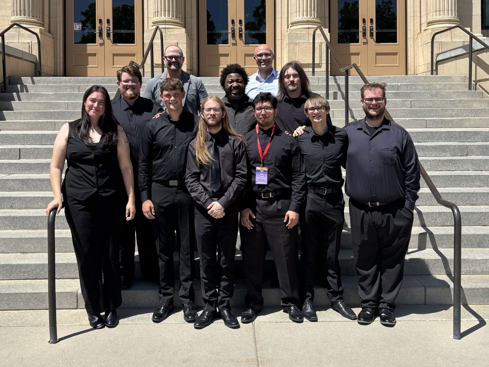 Students pose on a building's steps