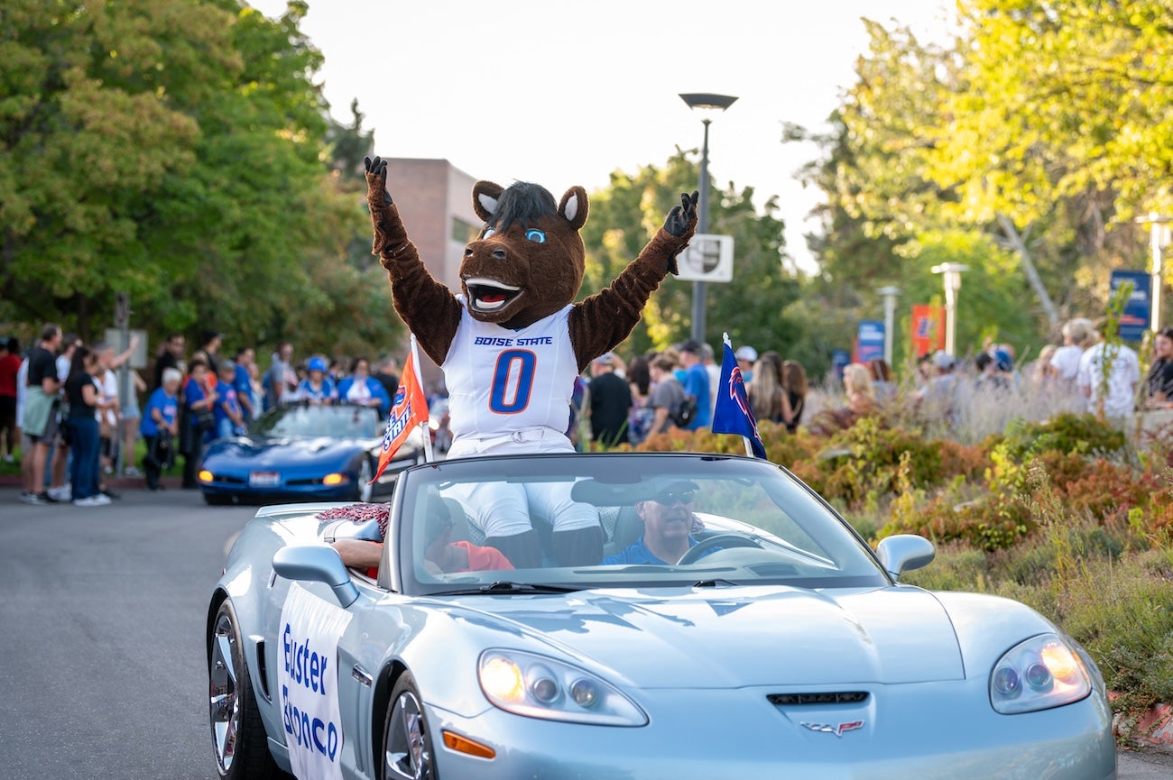 Buster Bronco in a convertible in a parade