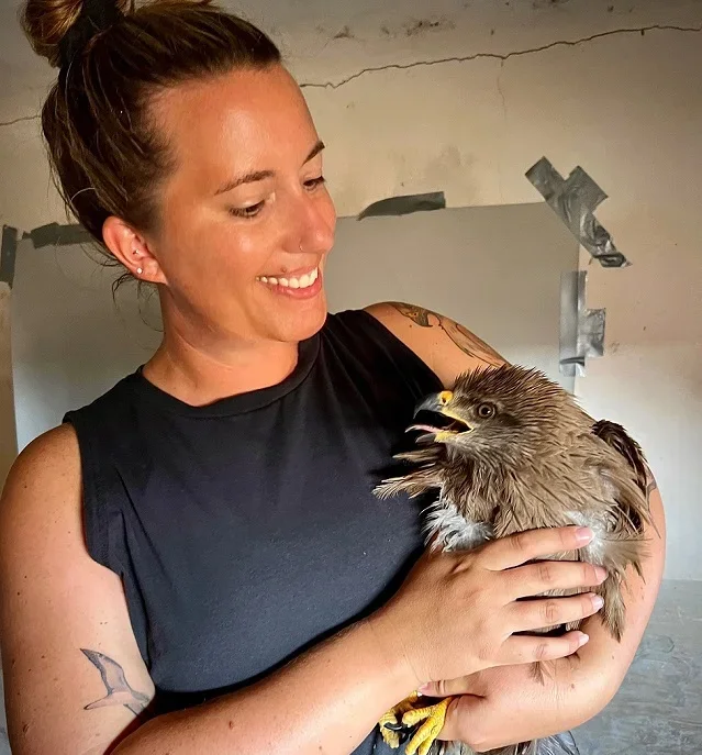 A person holds a bird