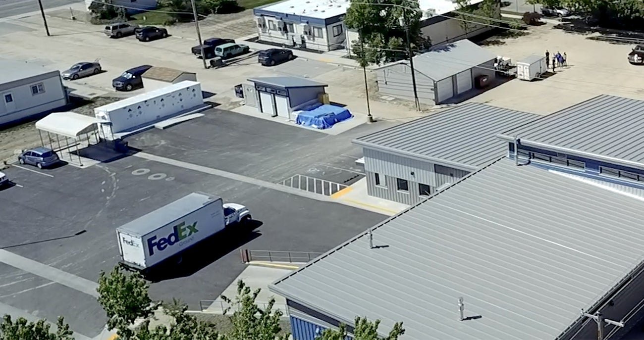 Aerial photo of a FedEx truck preparing to unload on campus