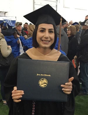 Morgan Prince posing with her degree from Boise State