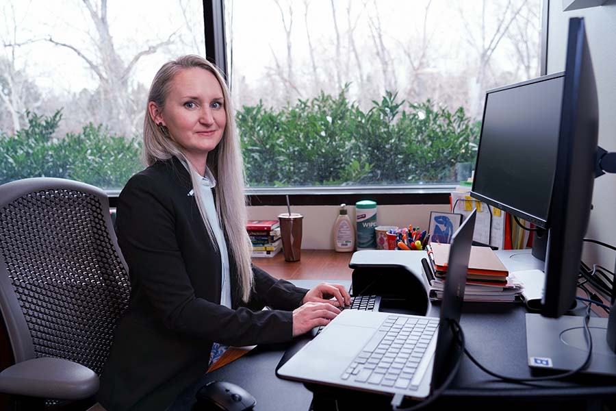 Jessi Boyer, Interdisciplinary Professional Studies student, working at her desk