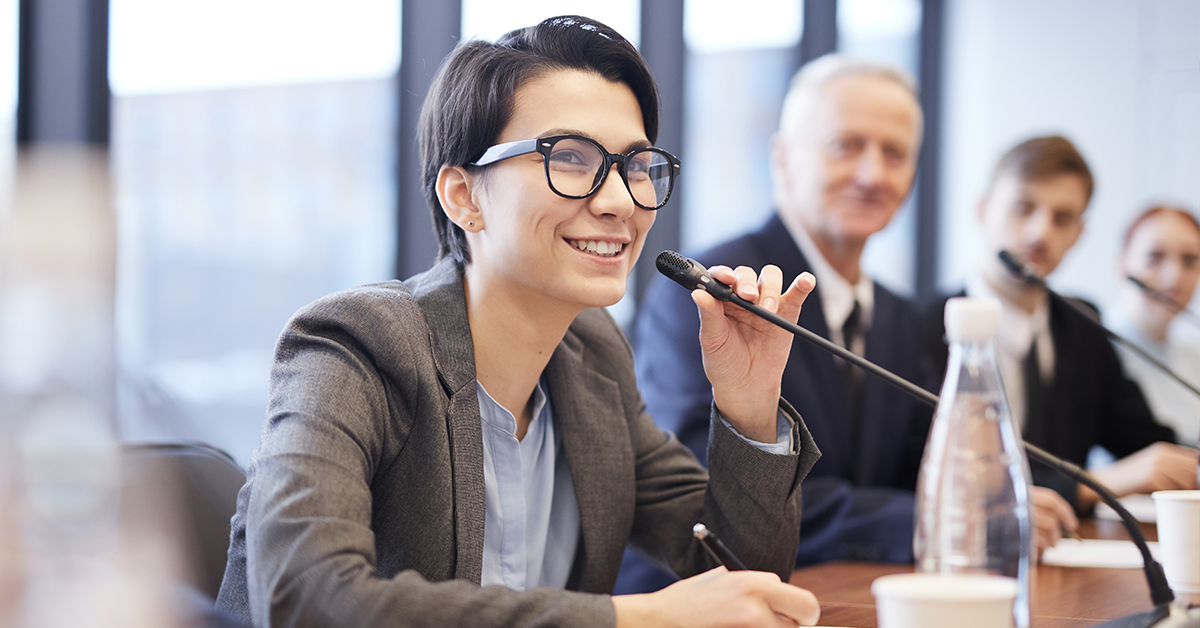 An executive speaks into a microphone