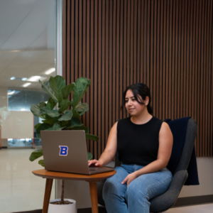 woman sitting in a chair looking at her computer
