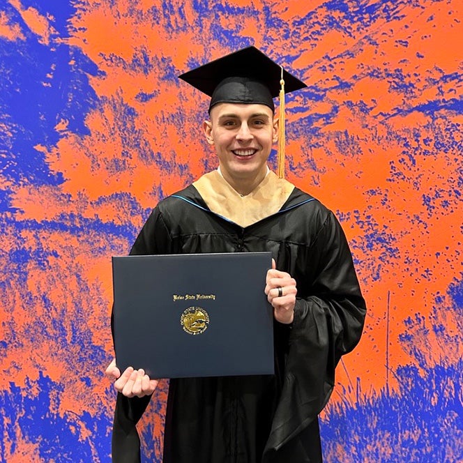 Master of Business Administration graduate, Logan Browning, in his graduation cap and gown