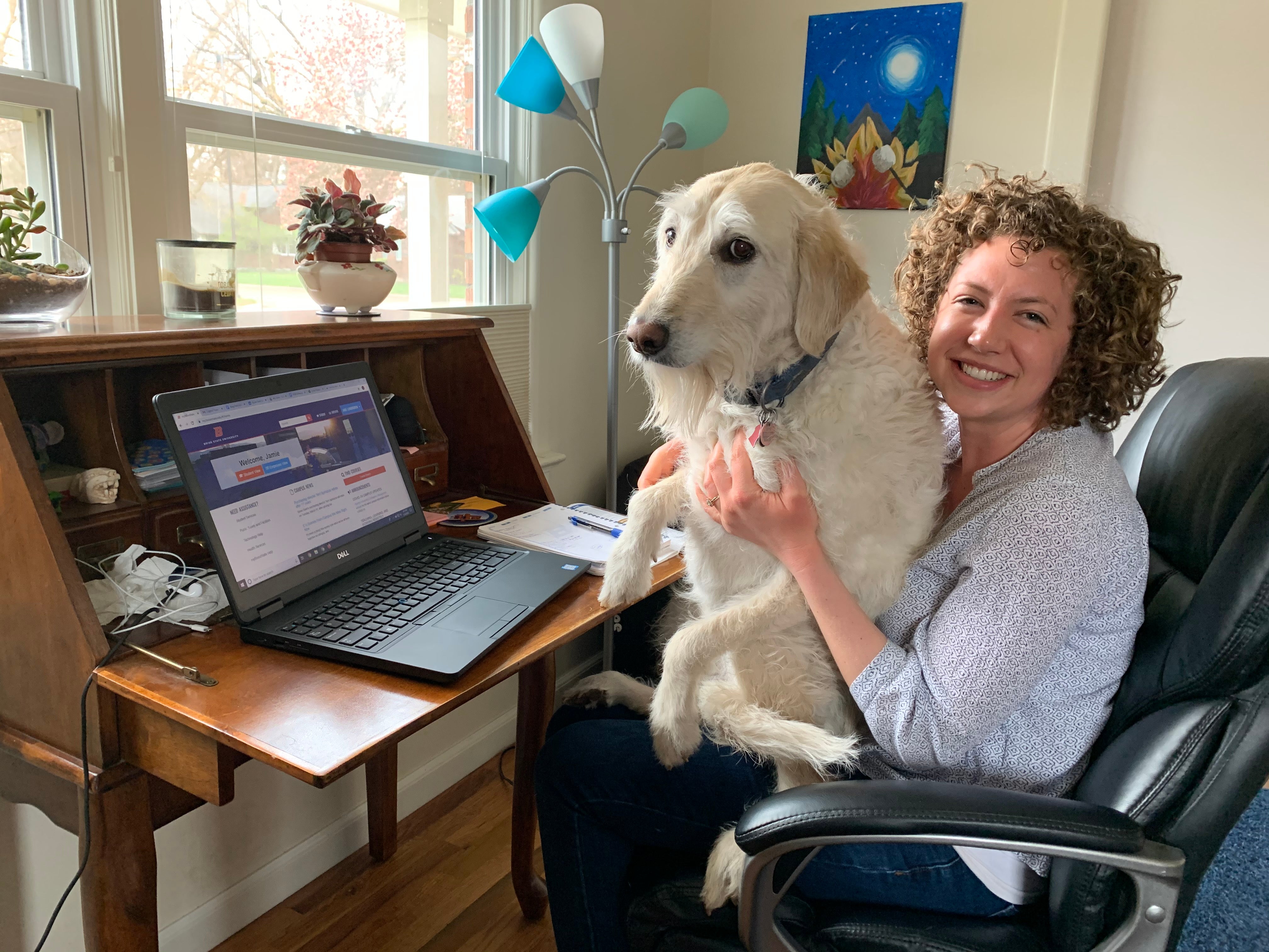 Jamie Lundergreen at her work-from-home desk with her dog, Wookiee, on her lap