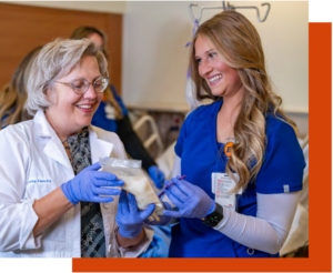 faculty working with a nursing student