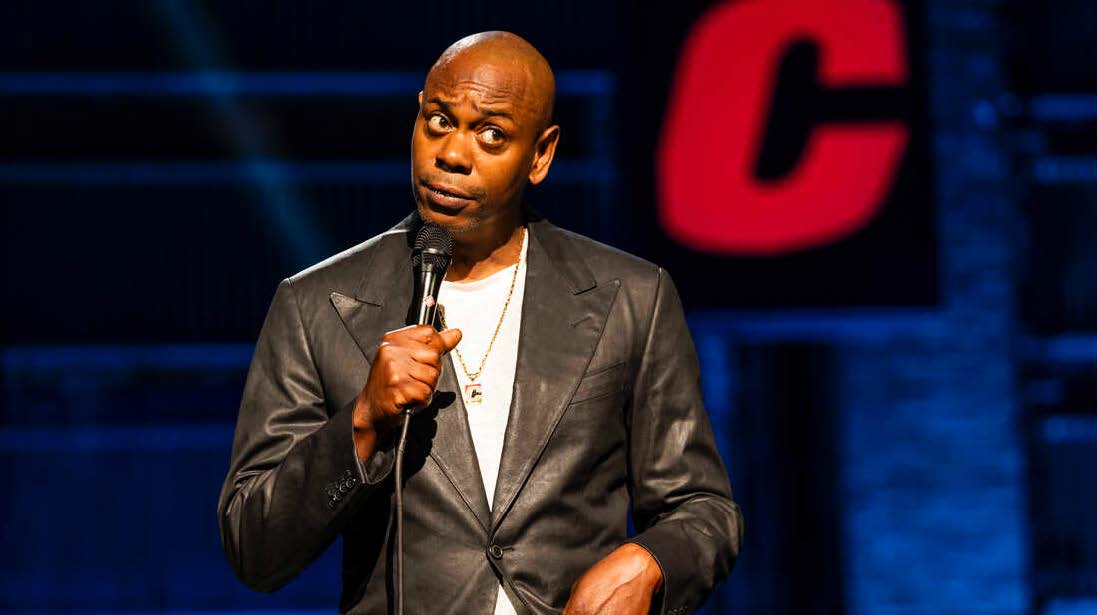 Dave Chapelle holding a microphone
