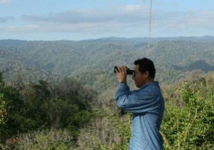 Vargas looking through binoculars